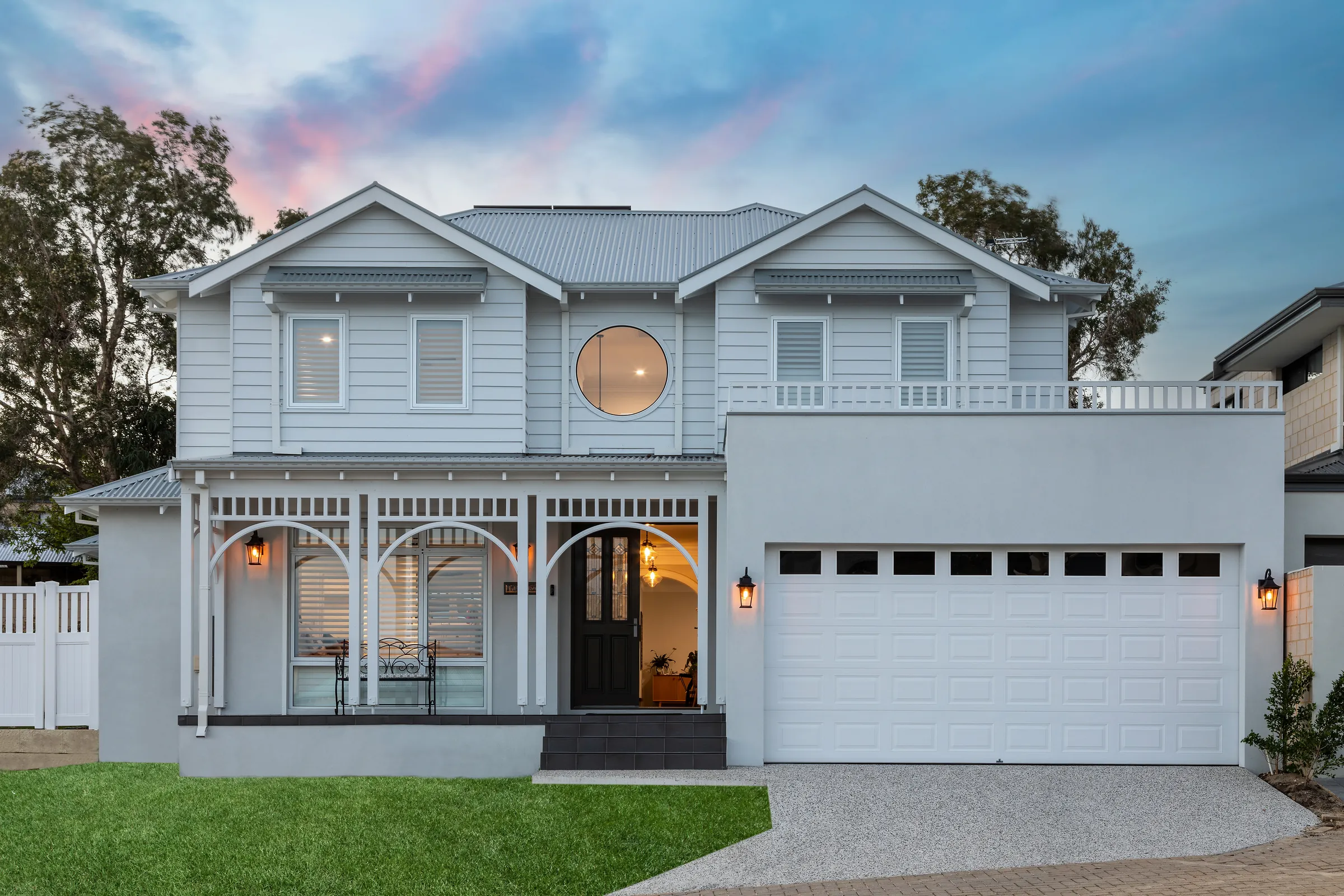 Duncraig Residence, Hampton-style family home at dusk